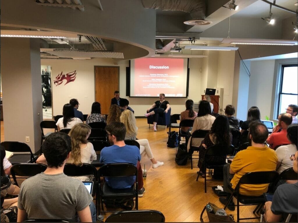 A photograph of UChicagoGRAD headquarters, full of grad students seated and in discussion during the Academic Job Market Summer Camp in 2019. 