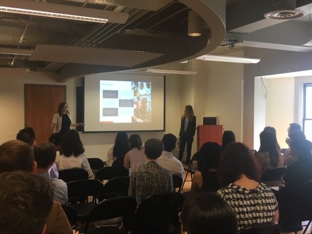 Students in UChicagoGRAD Headquarters listen to a speaker.