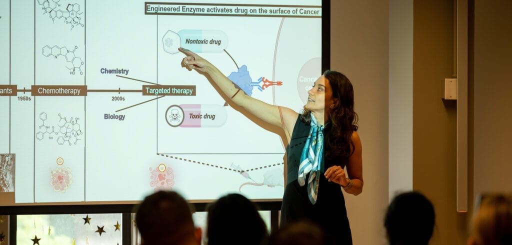 A picture of a PhD student presenting at the Three Minute Thesis competition